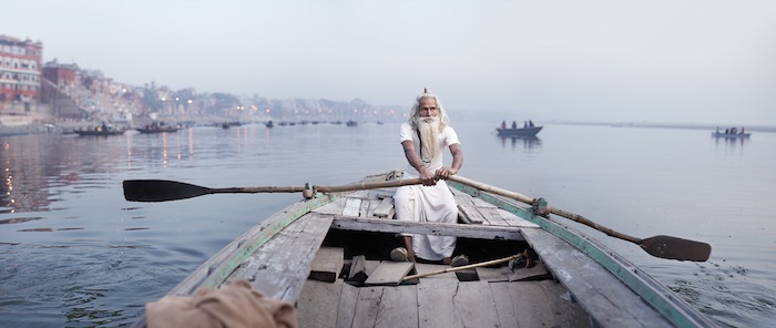 Аскет Баба Виджай Нунд плывёт в лодке по реке Ганг