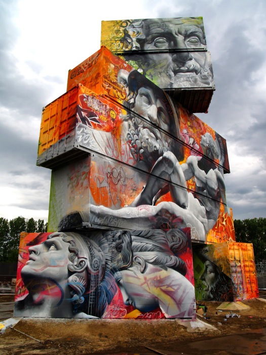 Граффити от испанского дуэта на скульптуре из транспортных тар.