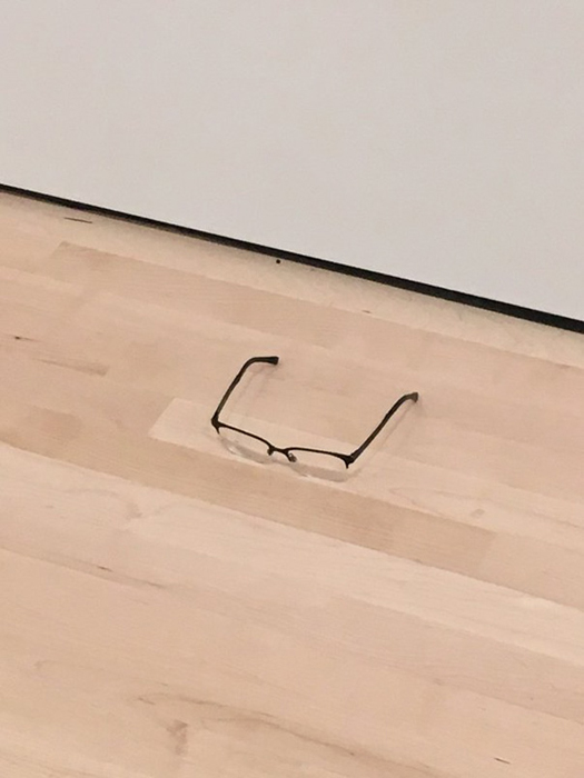 Обычные очки, лежащие на полу.