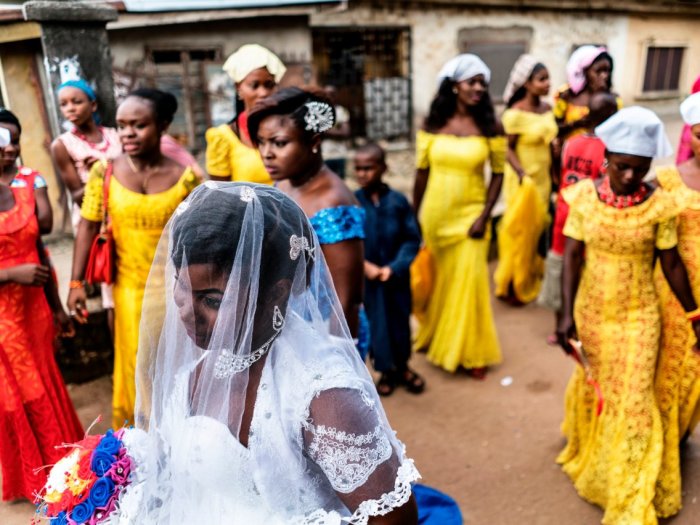 Невеста и члены свадебной вечеринки традиционно носят сложные головные уборы, которые дополняют смелые цветные платья. Автор: Marco Longari.