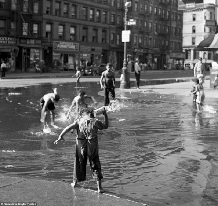 Дети играются на заполненной водой улице в Гарлеме, 1939 год.