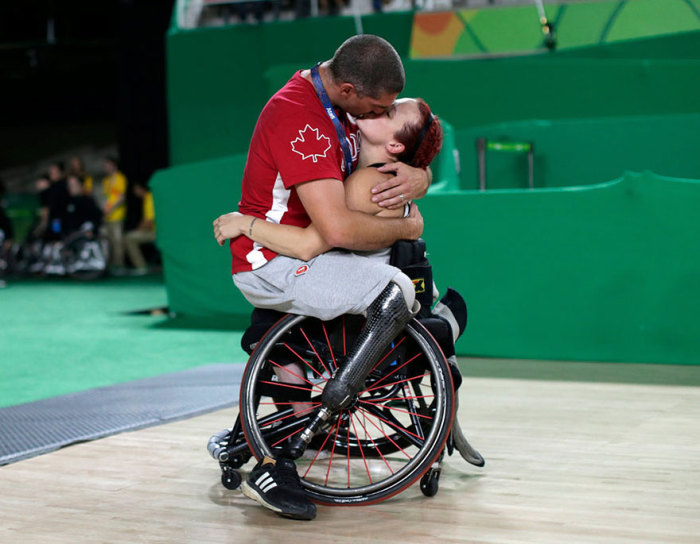 Игрок сборной Канады по баскетболу Адам Лянча целует от радости свою жену Джейми Джевеллс после того, как ее команда победила в соревновании в Рио-де-Жанейро.