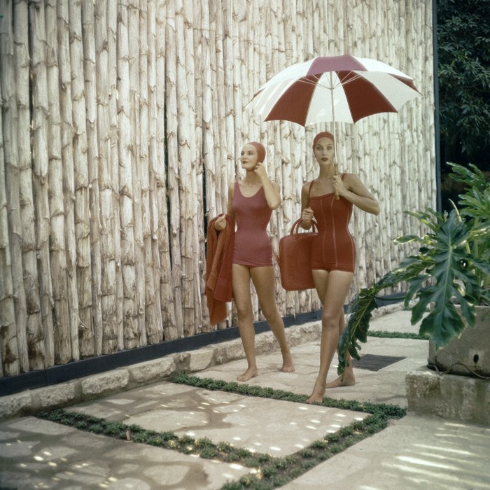 Две модницы в красных купальниках идущие с пляжа. 1960-е годы. 