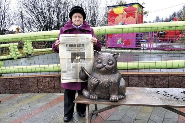 Хозяйка легендарного кота с газетой, где написана статья о его счастливом возвращении. / Фото: www.kpcdn.net